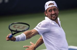 Sandgren hit in groin, defaults after striking line judge with ball
